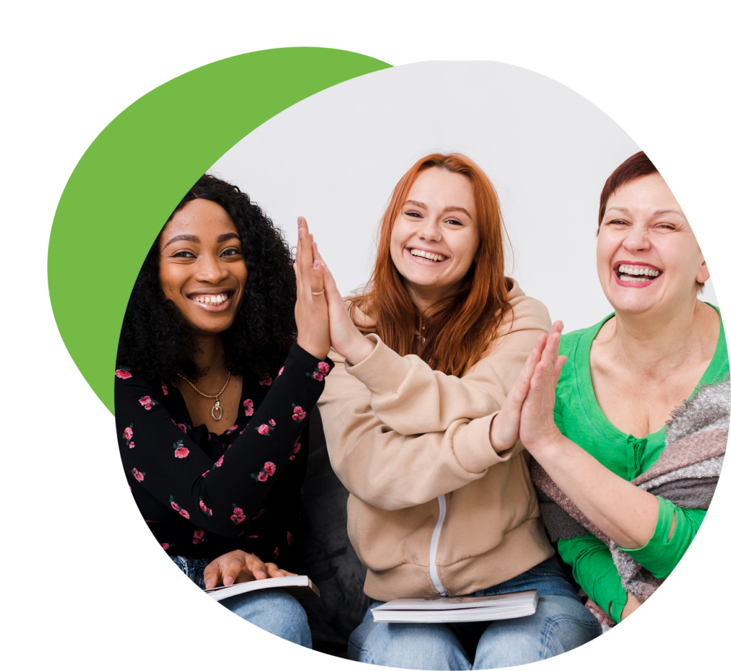 Trois femmes souriantes se félicitent.